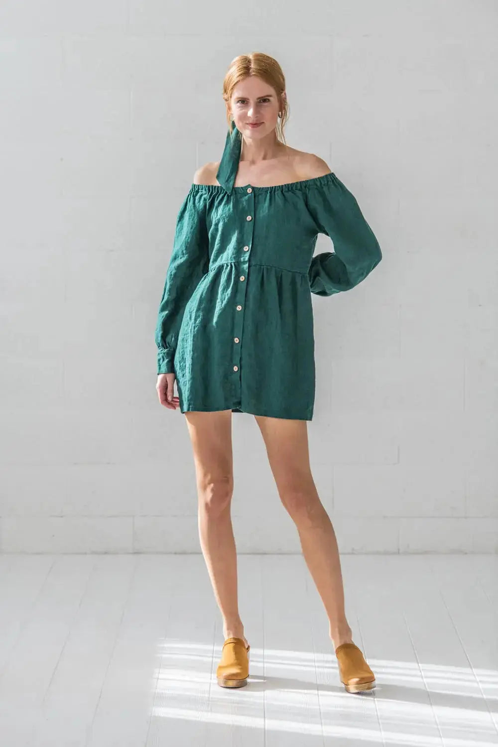 Front view of linen balloon sleeve mini dress showing full-length coconut button
