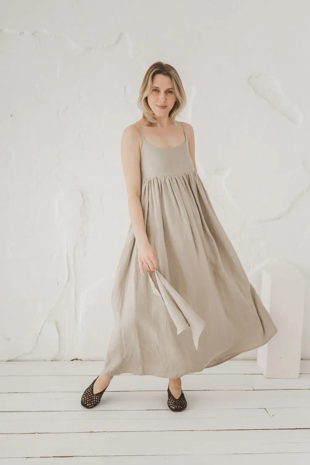 Linen maxi dress in motion, flowing silhouette, front view