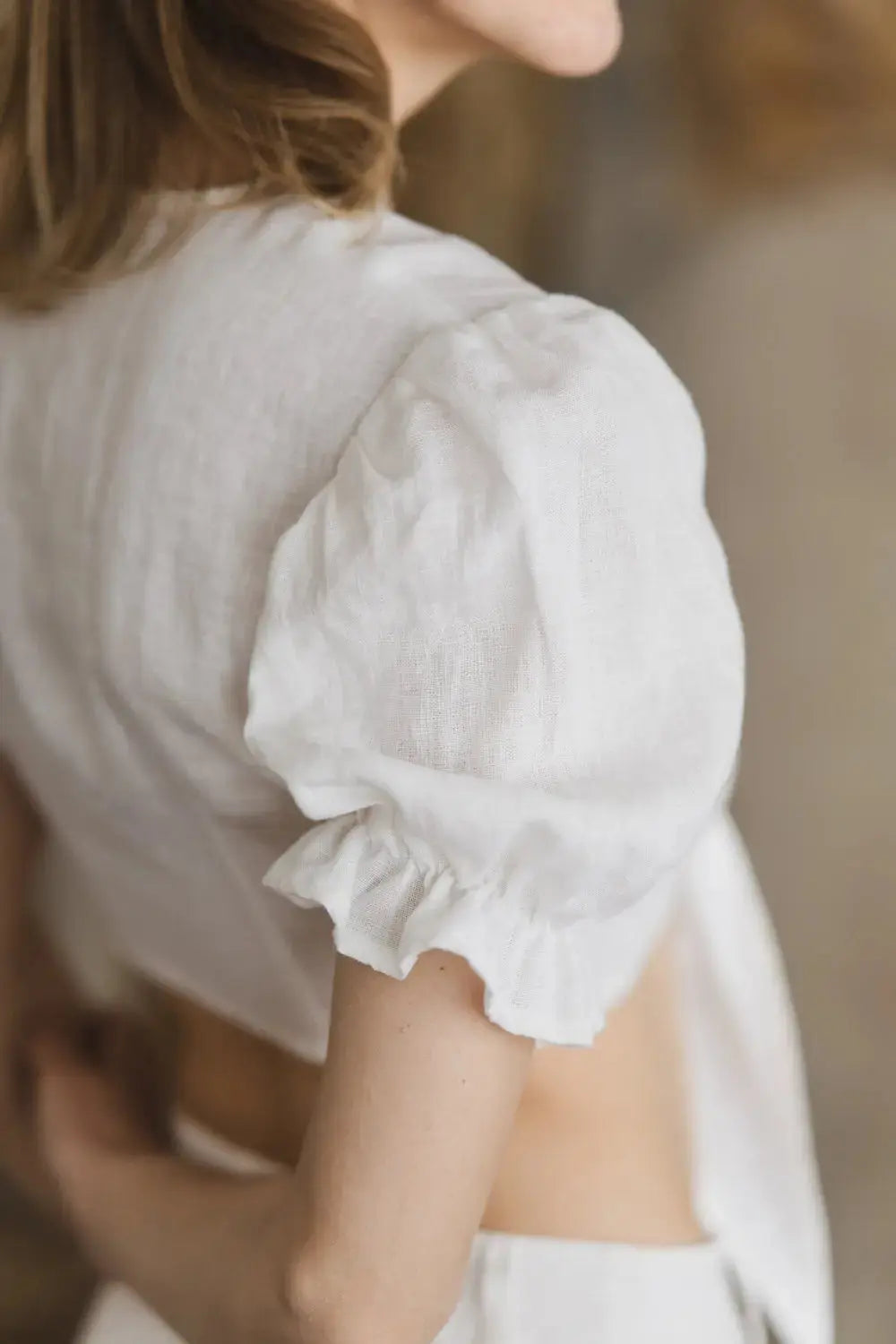 Linen tie-front crop top with puff sleeves and ruffled cuffs, sleeve detail