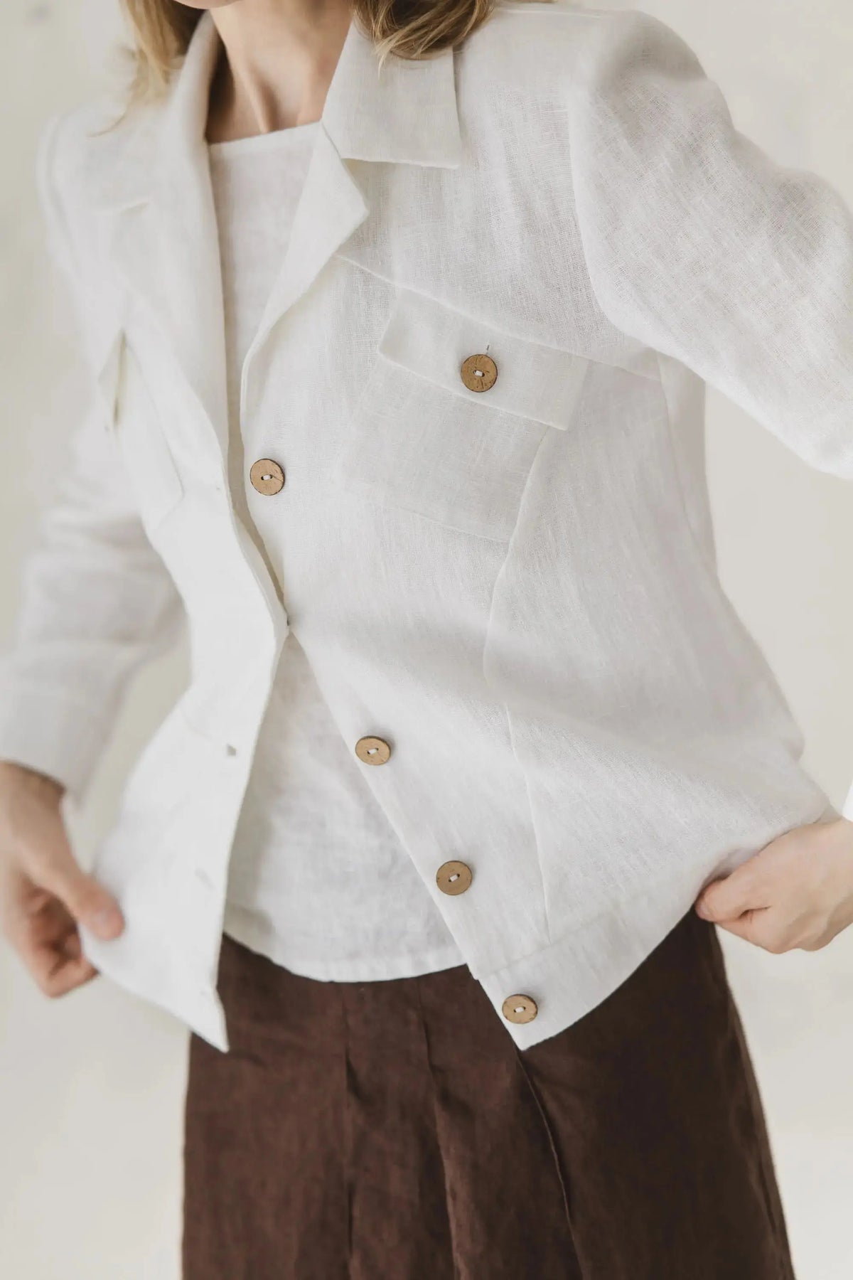 Close-up of pocket and button details on The Riviera white heavyweight linen blazer 254.