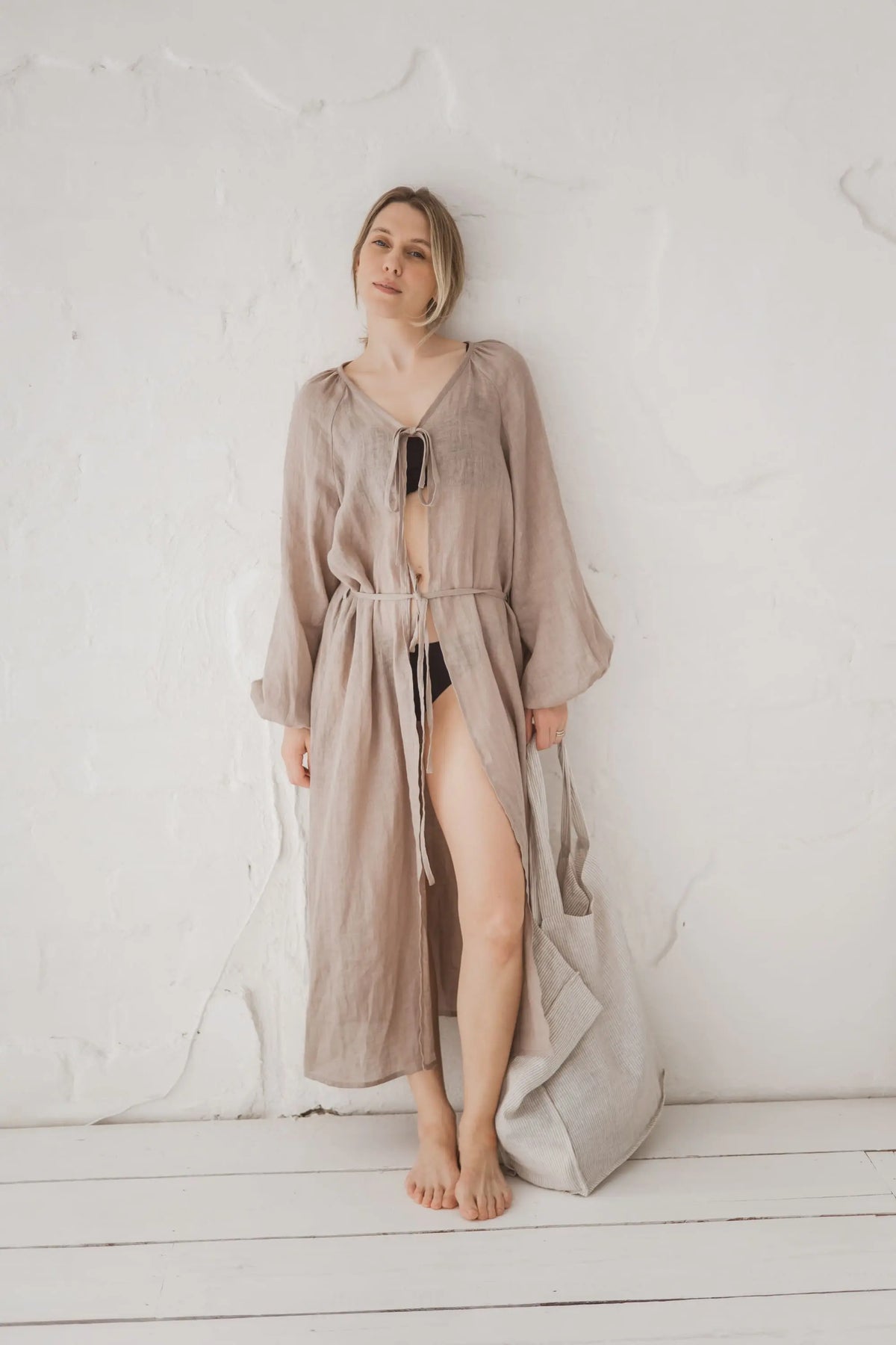 Woman in a natural linen kaftan open at the front, full length front view