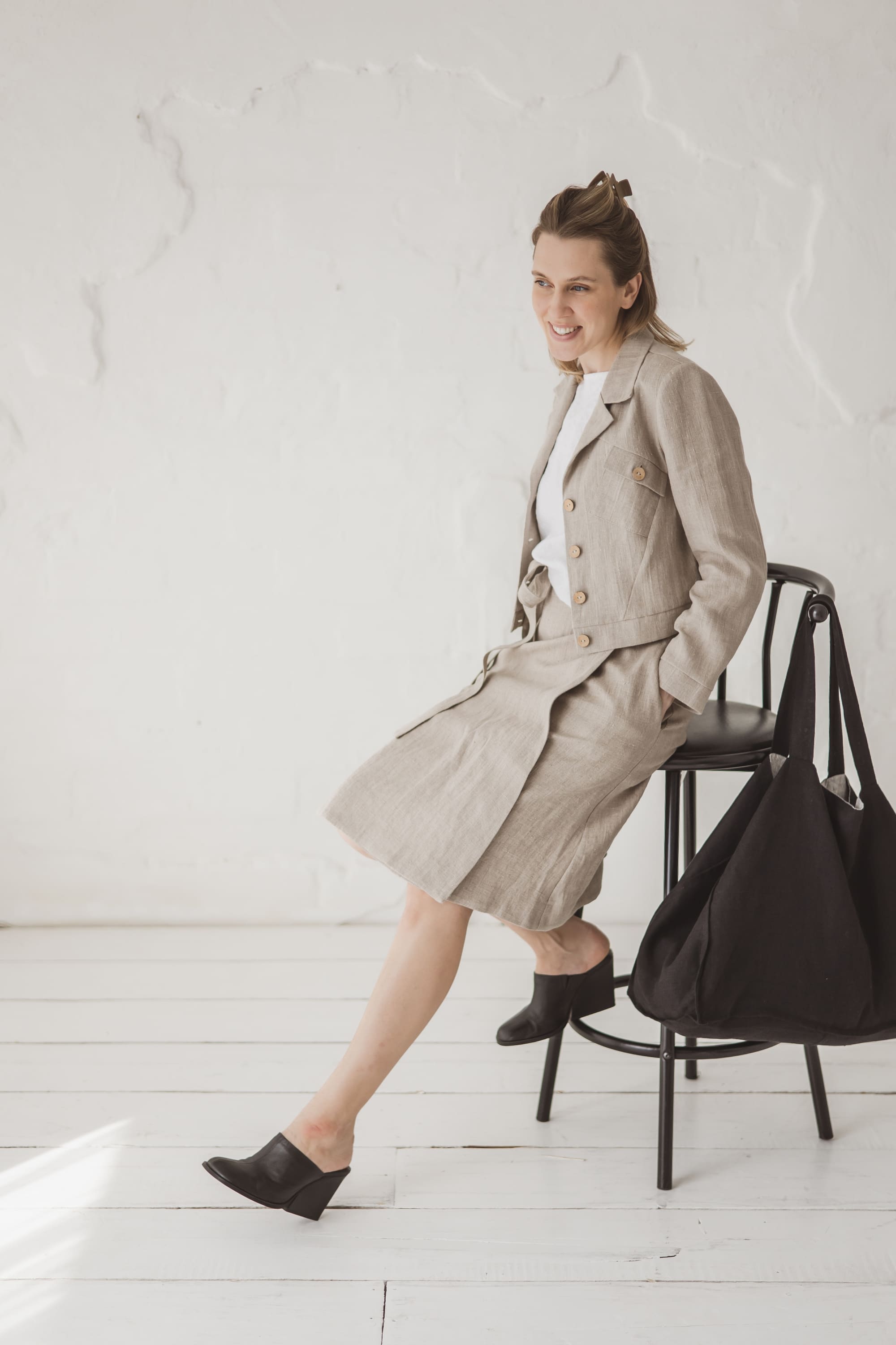 Structured Cropped Linen Blazer — side view with linen skirt and black tote bag