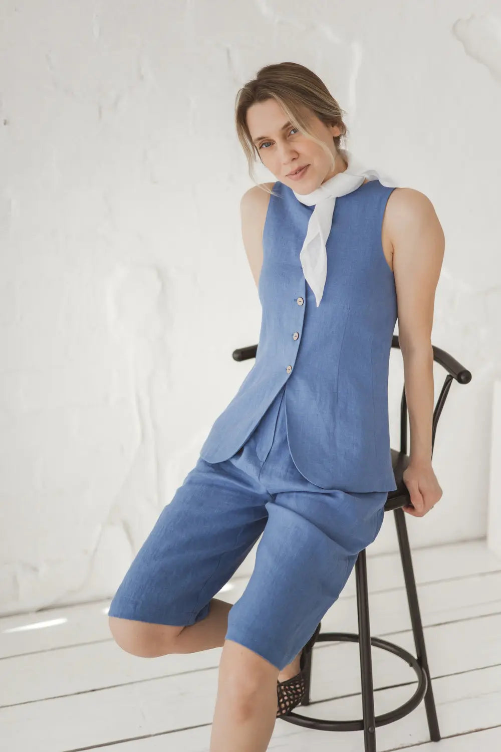 Structured linen vest with curved hem and white linen neck scarf, front view